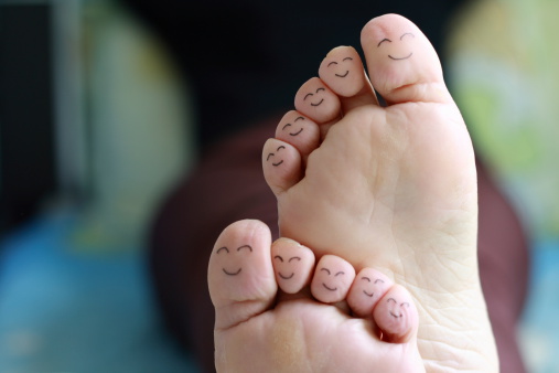 Feet with happy face drawings of different characters