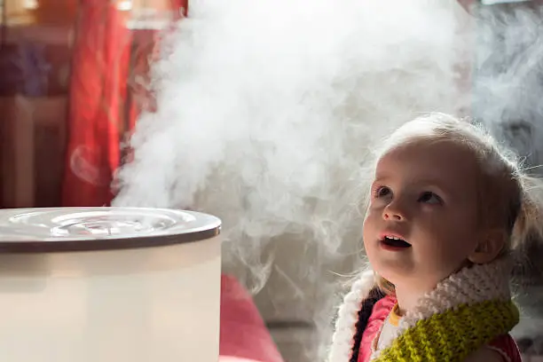 Photo of Baby girl mystifiied by a humidifier