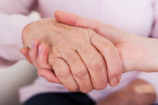 istock Young Woman Holding Senior Woman's Hand 177712118