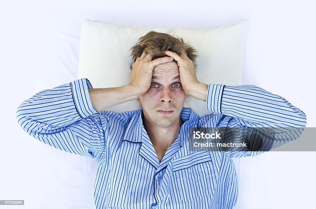 Can't sleep A man not able to get to sleep because of stress Sleeping Stock Photo