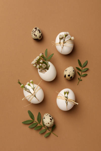 istock Festive composition with eggs and floral decor on brown background, flat lay. Happy Easter 1777136653