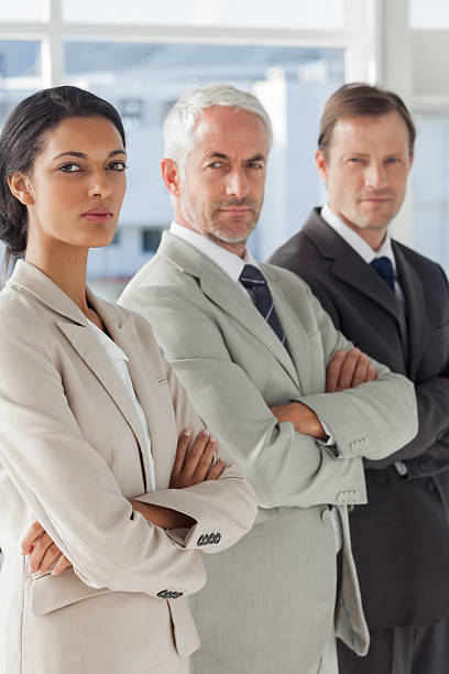 istock Three serious business people standing together 177713847
