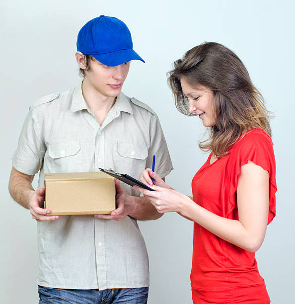 istock Young courier deliver package to pretty woman 177713869