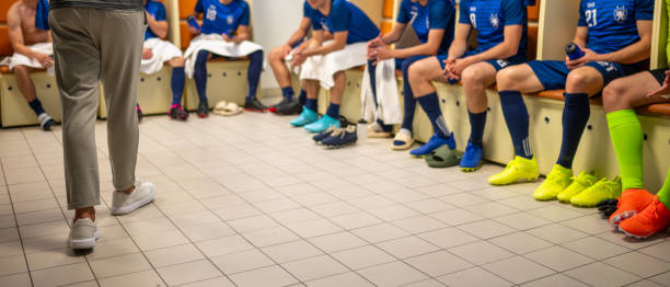 istock Soccer coach talking with players in locker room 1777139768
