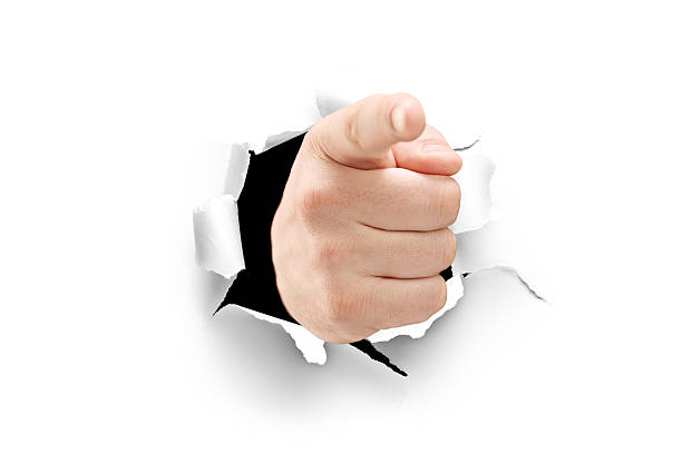 istock Male hand pointing through a hole in paper 177714172