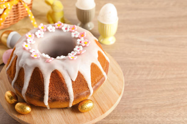 istock Delicious Easter cake decorated with sprinkles near eggs on wooden table, closeup. Space for text 1777145076