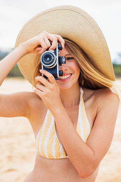 istock Beautiful Woman at the Beach with Camera 177714537