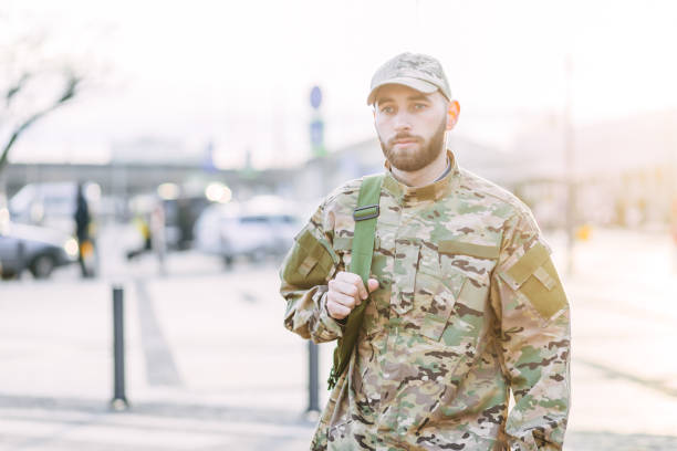 istock young military man in a camouflage uniform and a cap, standing 1777145612