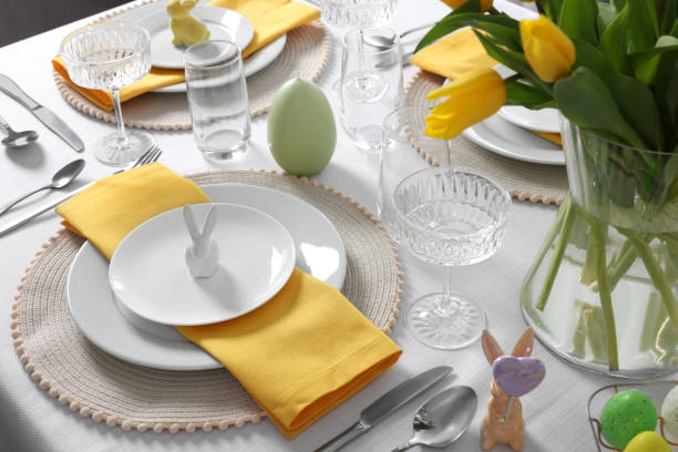 istock Festive table setting with glasses and vase of tulips. Easter celebration 1777145624