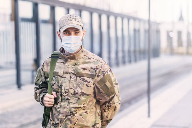 istock A man in an American army uniform. Protective blue medical mask 1777145629