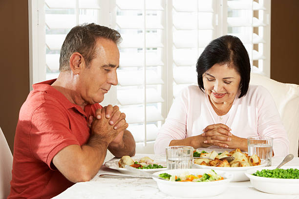 istock Senior Couple Saying Grace Before Meal At Home 177714685