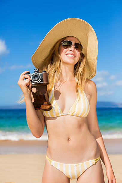 istock Beautiful Woman at the Beach with Camera 177714985