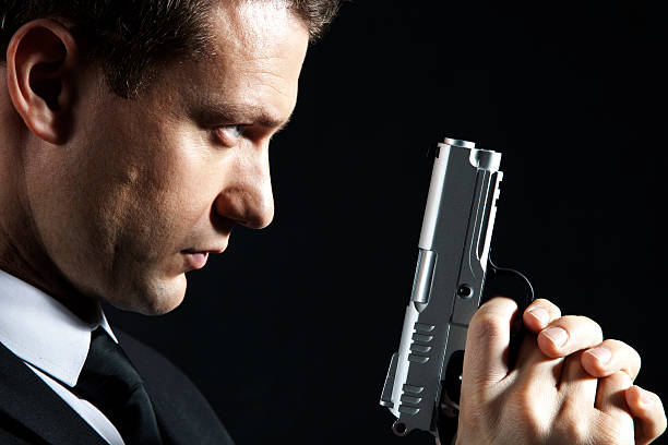 secret agent - bodyguard holding gun 20s stock-fotos und bilder