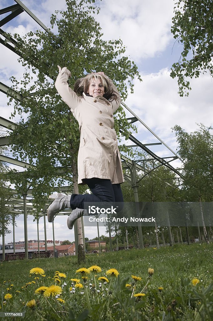 Saut de femme d'âge mûr droite large - Photo de 50-54 ans libre de droits