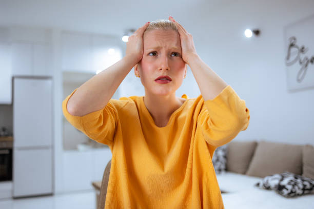 istock Young woman having headache at home 1777161616