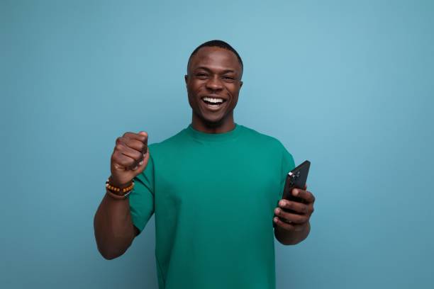istock young handsome american guy dressed in a basic t-shirt uses a smartphone 1777163691