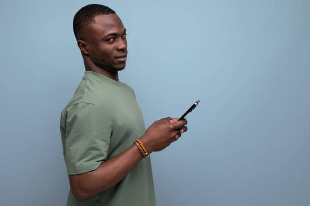 istock 30 year old handsome american man dressed in a basic t-shirt communicates in social networks using a smartphone 1777164237