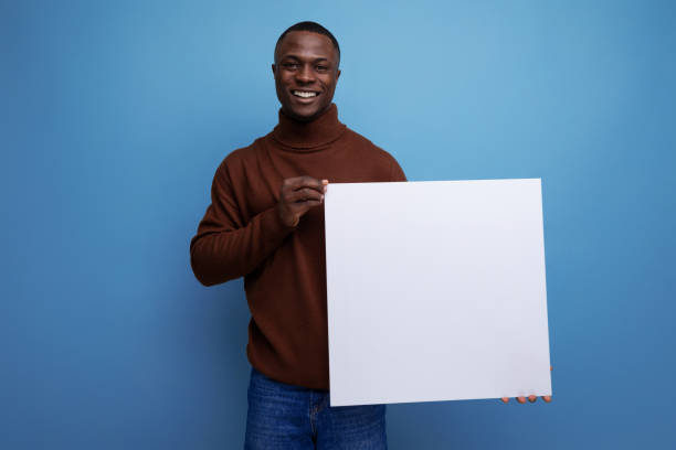 istock young american brunette man holding a square white screen for notes 1777165372