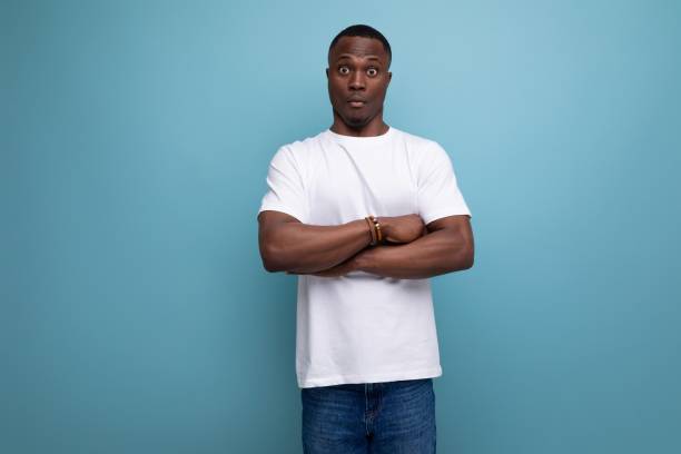 istock handsome young african man in white t-shirt on blue background with copy space 1777165390