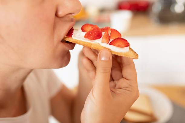 istock woman eating strawberry sandwich while dieting 1777165980