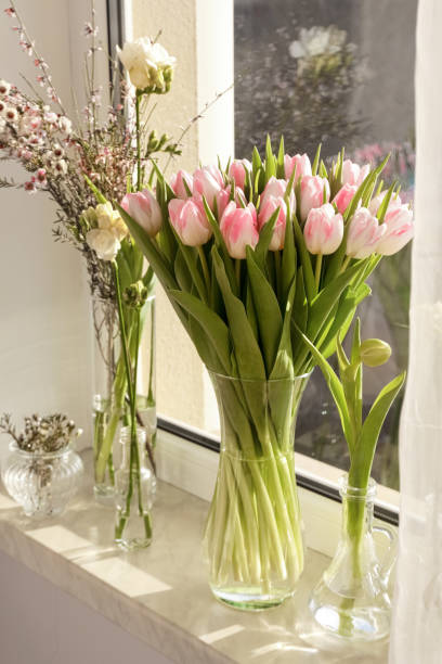 istock Many different spring flowers and branches with leaves on windowsill indoors 1777168609