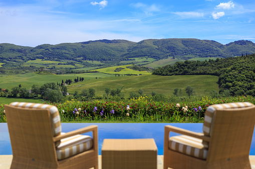 Outdoor chair and pool landscape background in val d'Orcia in Tuscany