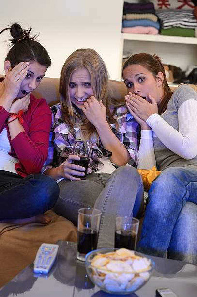 istock Scared girls watching horror movie on television 177717589