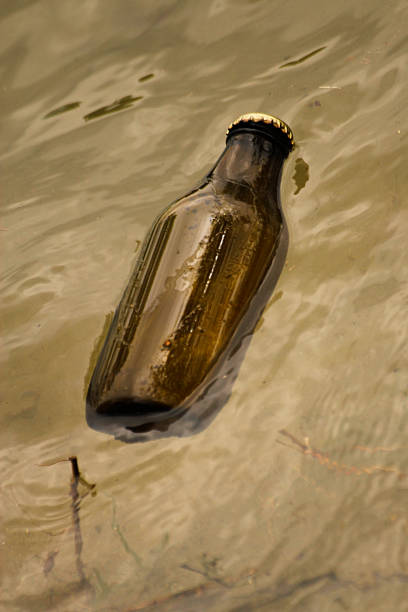 istock Glass bottle floating in a river 177718827