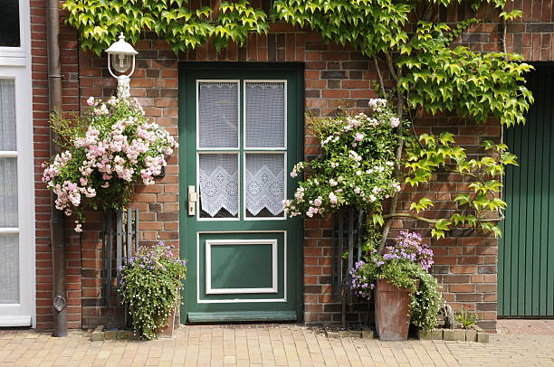 Vintage Wooden Doorway and Colorful of Flowers Decoration, Home Decorative Design and Plantation. Single Wooden Door in Old Town at Switzerland.