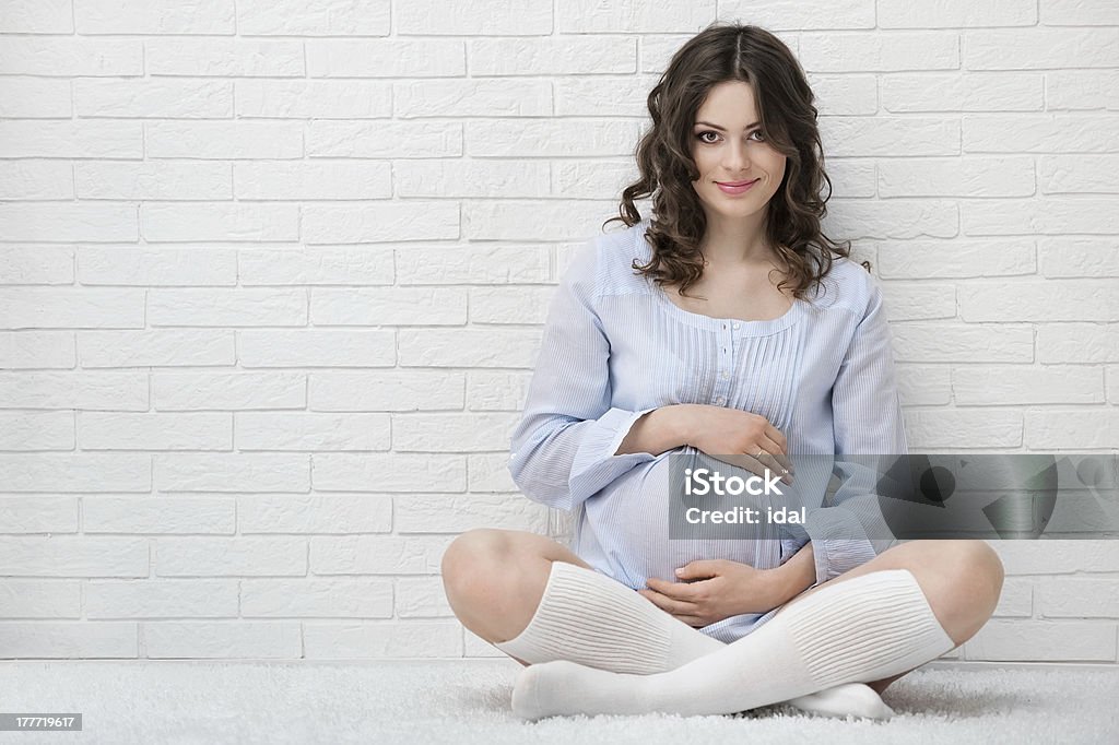 Portrait of the young pregnant woman Portrait of a young pregnant woman in the interior Abdomen Stock Photo