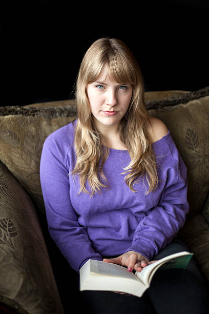 istock Angry Young Woman with Beautiful Blue Eyes Reading a Book 177721032