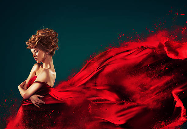 istock Woman in red blowing flying dress dissolving splash 177721900