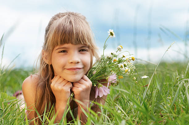 istock The smiling girl is lying on grass 177722141