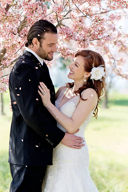 istock Bridal Couple Showered by Cherry Blossom Petals 177722180