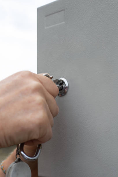 istock a man closes the lock on the electrical panel cover. Security of power supply control 1777223334