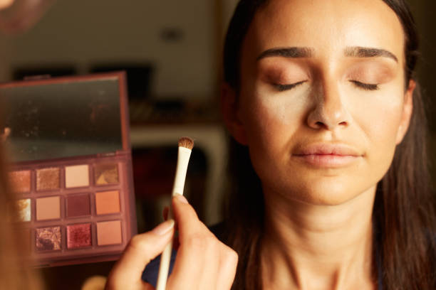istock woman applying make-up to woman's face 1777224920