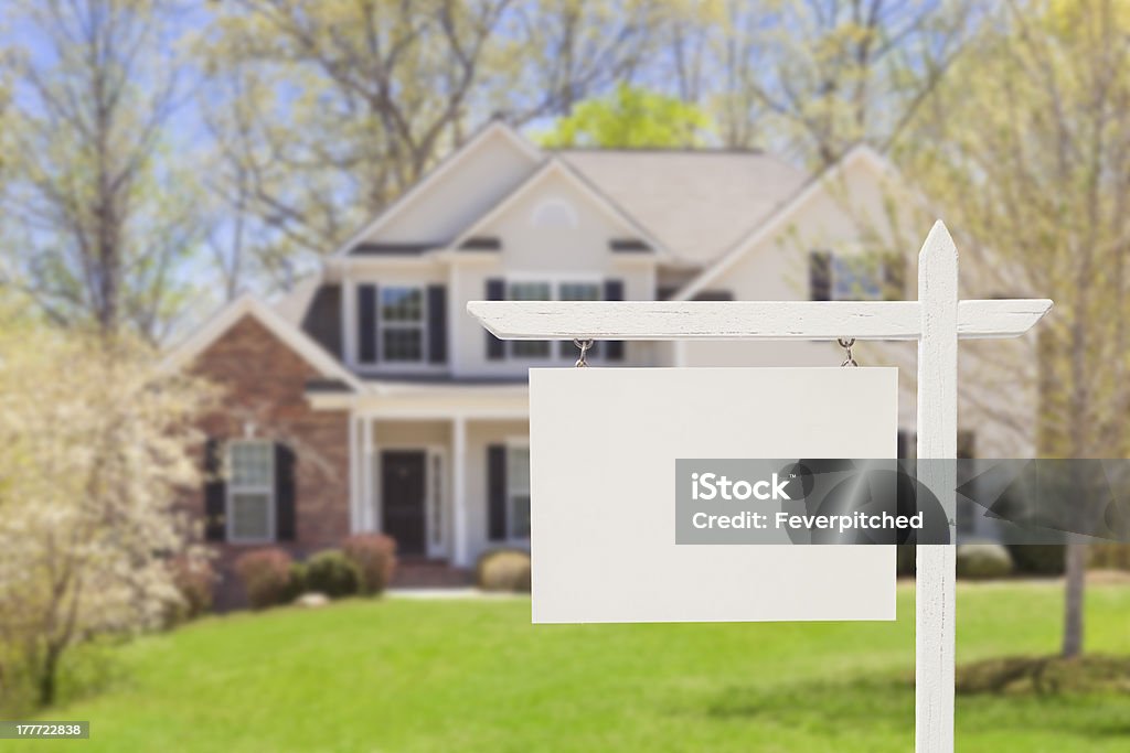 Blank Real Estate Sign in Front of New House "Blank Real Estate Sign in Front of Beautiful New House - Ready for Your Own Text, Message or Logo." For Sale Sign Stock Photo