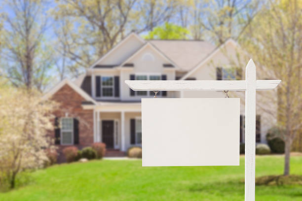Blank Real Estate Sign in Front of New House "Blank Real Estate Sign in Front of Beautiful New House - Ready for Your Own Text, Message or Logo." houses for sale stock pictures, royalty-free photos & images