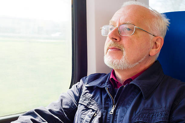 istock Relaxed old man sitting near the window in carriage 177723227