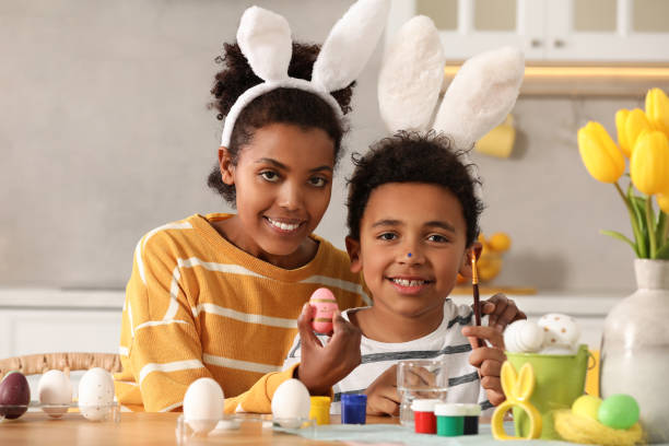 istock Happy African American mother and her cute son with Easter eggs at table in kitchen 1777233640
