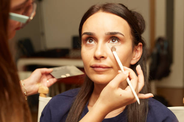 istock woman applying make-up to woman's face 1777235830