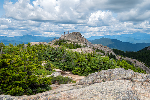 A group of Hikers make their way up Piper Trail on as they make their ascent toward Mount Choorua's summit. - Albany, New Hampshire.