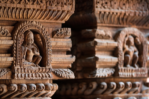 Carved wood wall decoration in Patan Durbar Square royal medieval palace and UNESCO World Heritage Site. Lalitpur, Nepal.