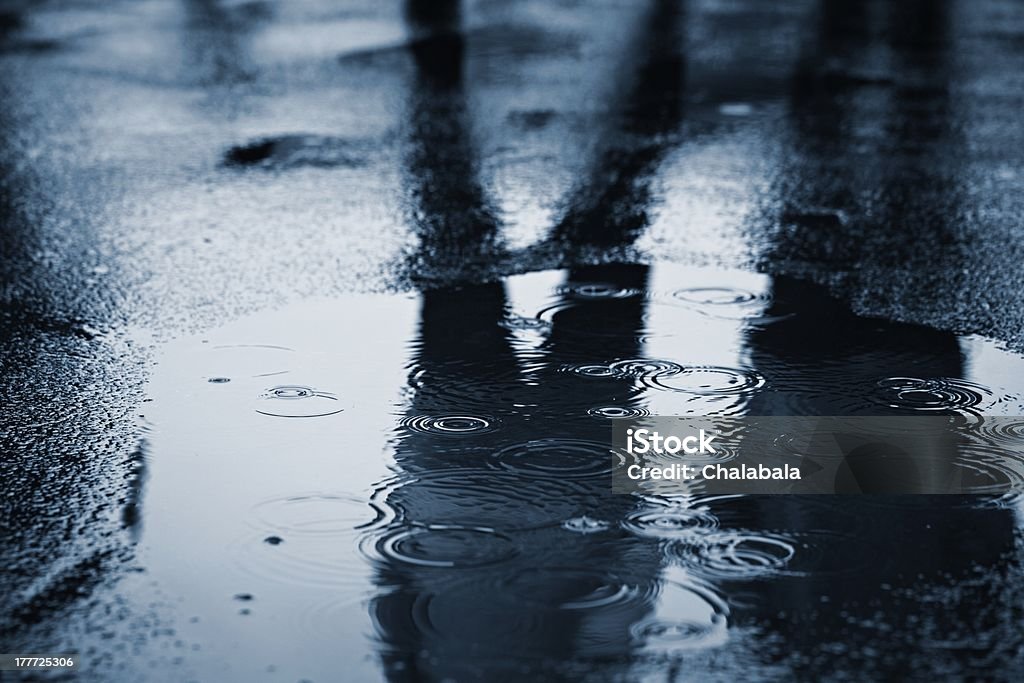 Rain Puddle of water in rain - selective focus Puddle Stock Photo