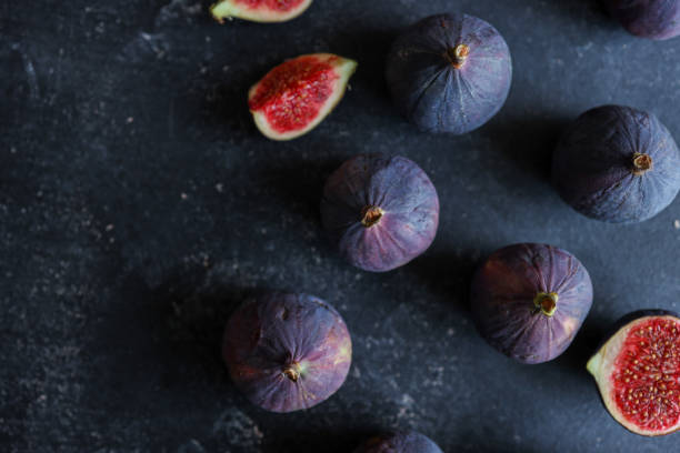 istock fresh ripe figs on dark background, top view 1777253483