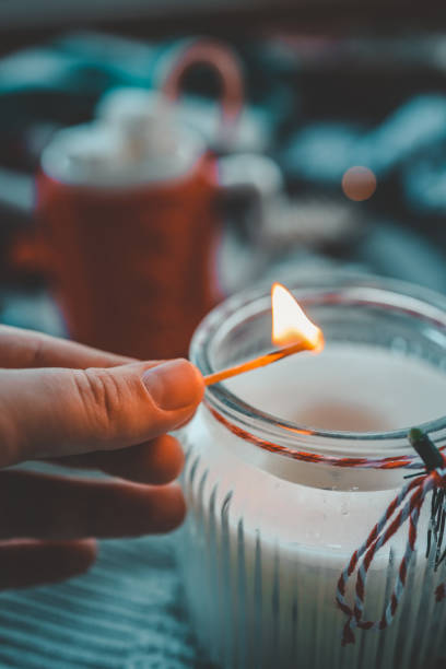 istock Hand with a match lights a candle, Christmas aesthetics 1777257447