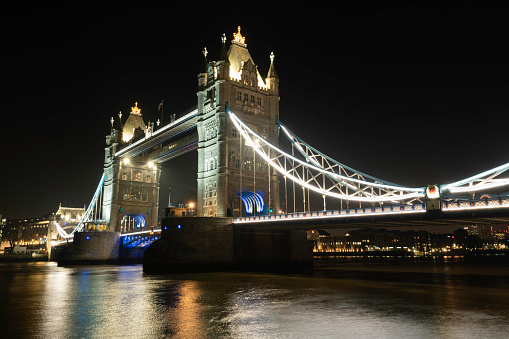 Illuminated Tower Bridge over the Thames River at night, London, England, United Kingdom