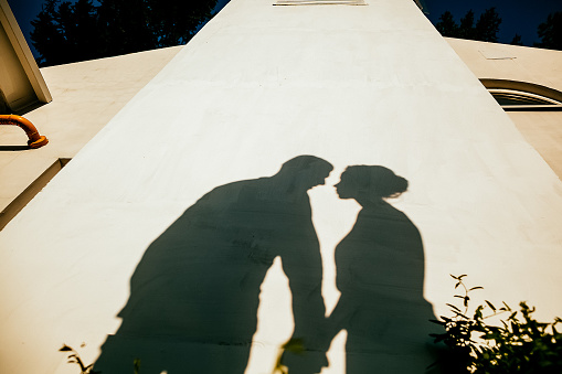 silhouette of a man and a woman, outdoors, shadows from people