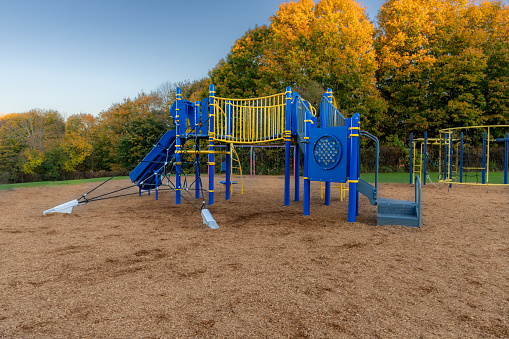 Unidentified typical elementary school playground with engineered wood fiber safety fall surface