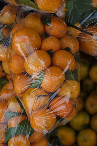 istock shantang orange with green leaves hanging on fruit stall. 1777262587